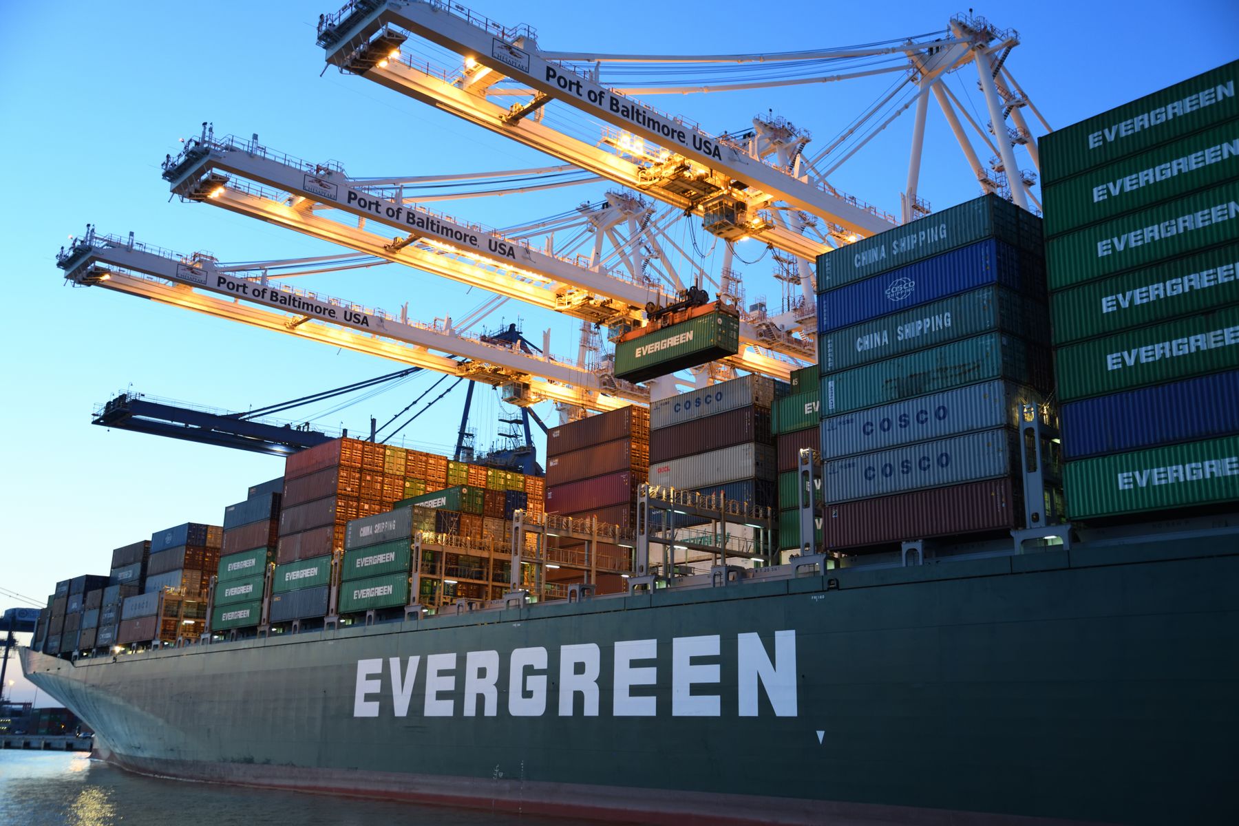 Container vessel loading at port under gantry cranes