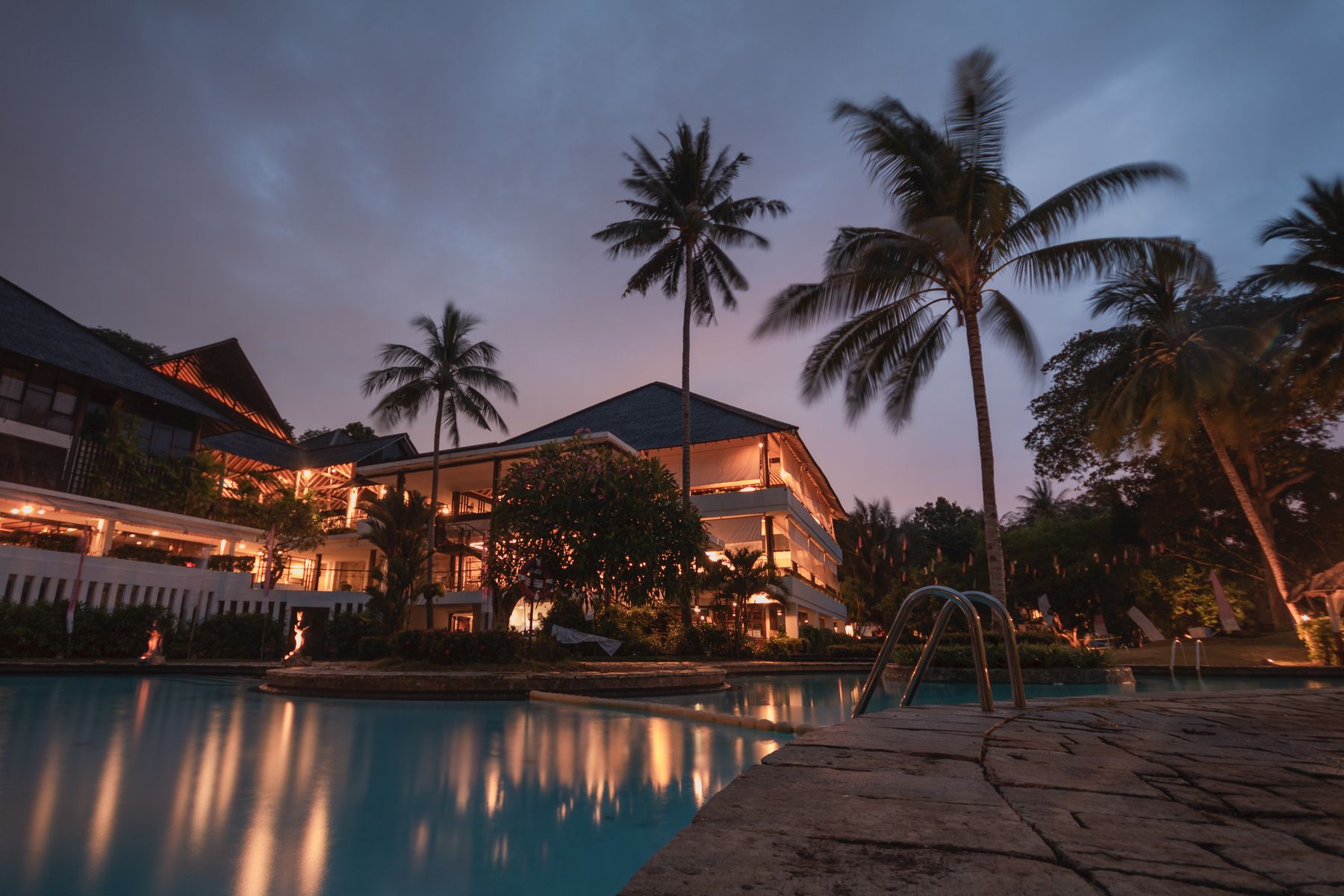 Luxury resort hotel and pool at dusk
